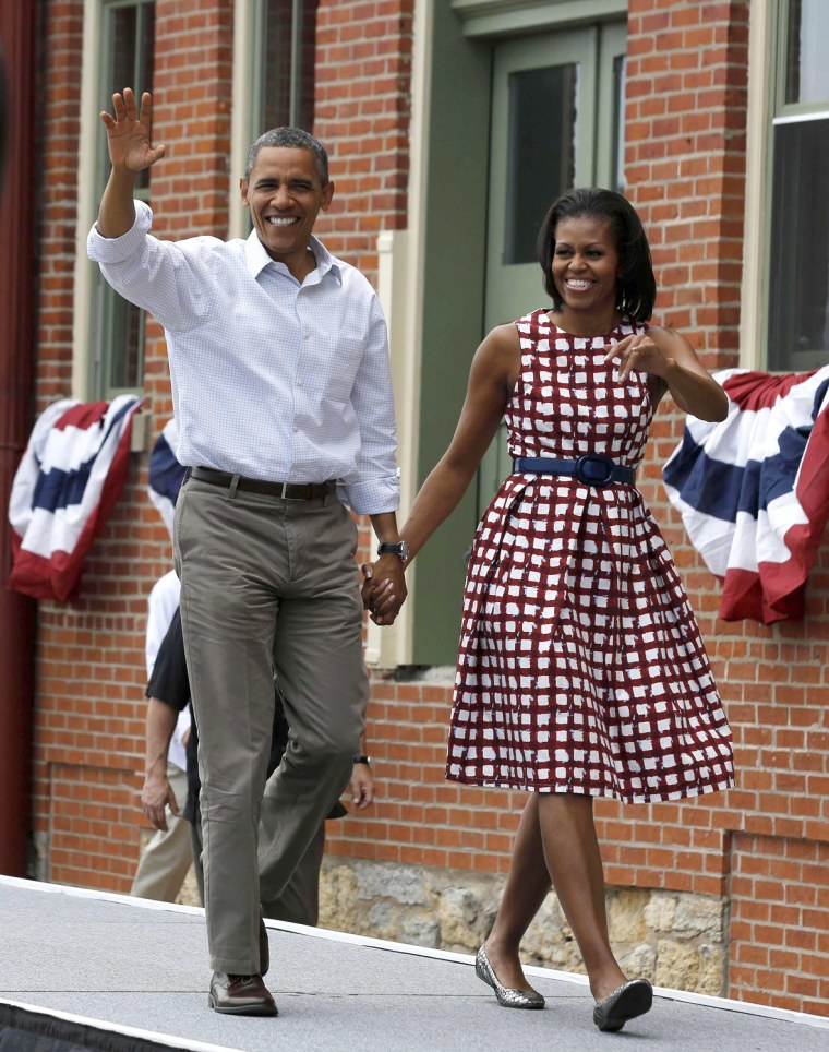 Image: U.S. President Barack Obama and first lady Michelle Obama arrive to speak in Dubuque, Iowa